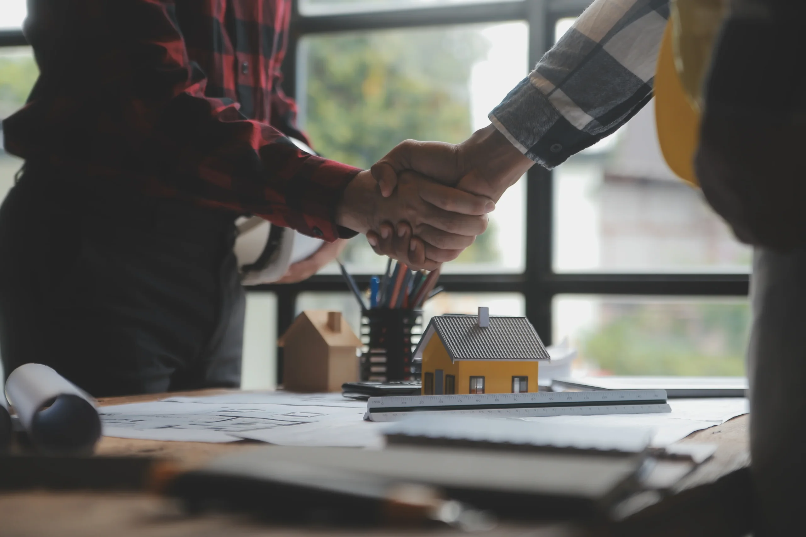 Restoration toronto professionals shaking hands in a house being restored.